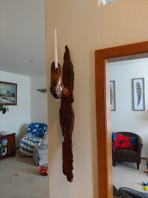 Driftwood candle wall sconce hanging in a home