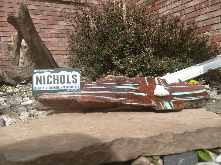 Wooden piece holding business sign