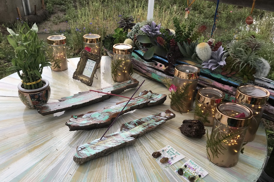 A table display of several driftwood art pieces